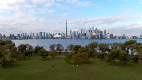 Toronto, Canada, aerial view, flyover shot of Centre Island showing iconic Toronto skyline and Lake Ontario during Fall season. 