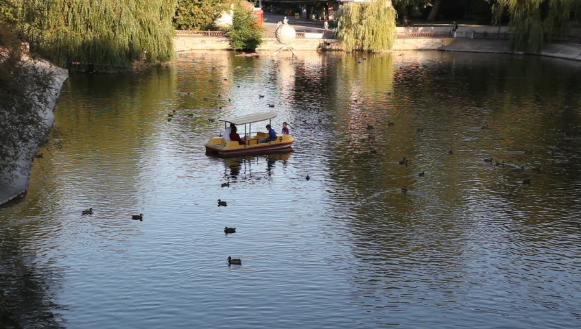 family resting on a catamaran in a lake on the water
