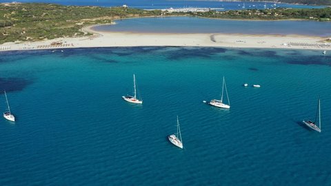 Panoramic view of sandy beach, yachts and sea with azure water, in Villasimius, Sardinia (Sardegna) island, Italy. Holidays, the best beaches in Sardinia. Porto Giunco beach, Villasimius, Sardinia.
