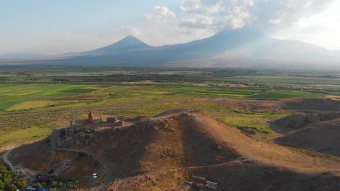 Khor Virap with Mount Ararat in background. The Khor Virap is an Armenian monastery located in the Ararat plain in Armenia, near the border with Turkey. Aerial flight video