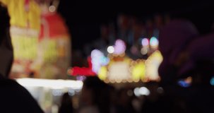 Carnival fair grounds at night. Defocused footage. Shot in 4K RAW on a cinema camera.