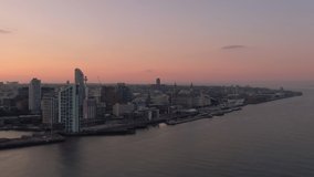 liverpool city skyline aerial view at dawn flying backwards over mersey river uk england