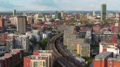 manchester city aerial view drone flying over train on railway uk england