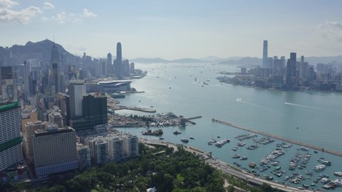 Hong Kong, Hong Kong SAR - August 4 2019: Drone Aerial of Hong Kong Island toward Victoria Harbour and Kowloon, Causeway bay Typhoon shelter and Victoria Park feature.