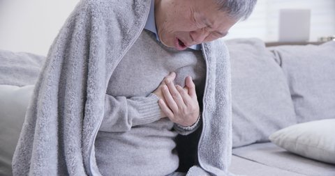 asian elderly sick man feeling sharp strong pain because of heart attack