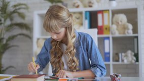 cute girl draws with crayons. 4K