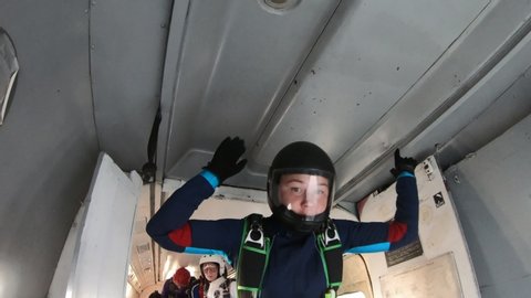 Skydiving. A girl is training to fly in the sky.