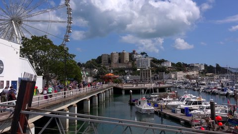 Torquay, Devon/England - August 10 2019: Torquay has been a popular English seaside destination since 1883 because of its mild climate and sunshine. Harbour with people and boats UK 4K.