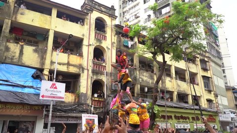 Mumbai, Maharashtra / India 08 23 2019  Devotees try to form a human pyramid to break a clay pot during Dahi Handi celebrations at Dadar Mumbai Maharashtra India