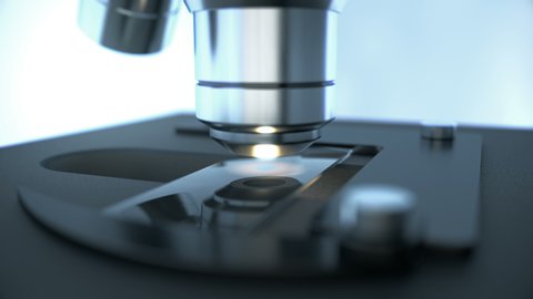 Close-up shot of scientific laboratory microscope with metal lens doing microbiology science research while inspecting chemical drop on prepared sample slide glass for medicine and chemistry industry