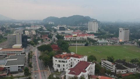 Ipoh, Perak, Malaysia, Circa July 2018 - Aerial view of Ipoh town in "Padang Ipoh" waving giant Perak flag. Video contain noise and grain.
