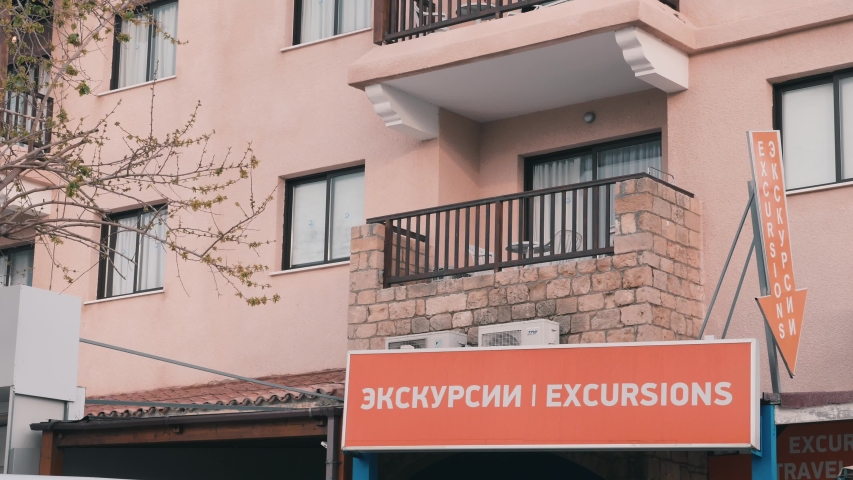 Billboard with excursion word. Poster on front of the building. House with advertisement. Placard of excursions. Tourist excursions