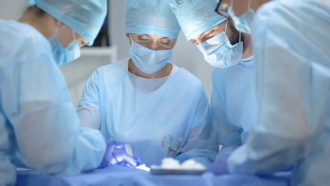 Serious surgeon team performing cardiothoracic surgery, hospital operation
