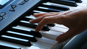 Female hands playing piano. A woman touches the keys with her fingers.