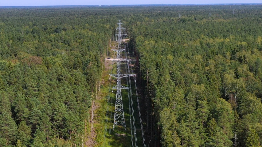 Tower of power lines in the forest. Electric tower line in Landscape view with Electricity and environmental problem concept. Ariel view High voltage power pylons.
 Royalty-Free Stock Footage #1036006604