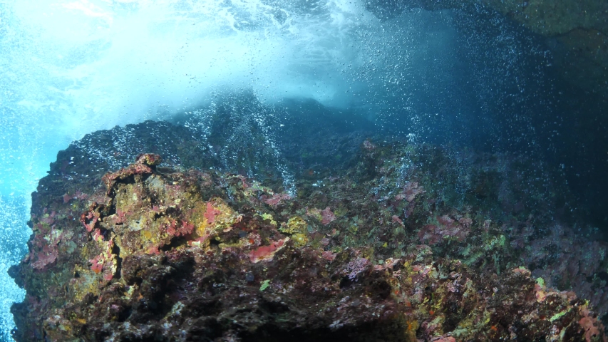 choppy water waves  and air  bubbles coming out of the rocks underwater cavern ocean scenery