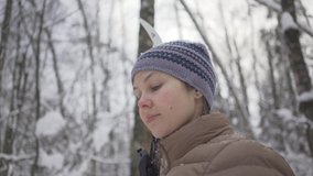 Video of female skier enjoying the snowy weather in winter forest