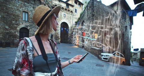 Augmented reality of digital point map searching app. Young tourist girl uses futuristic navigator on modern smartphone in hystorical old city. Animation of destination location. Future technology