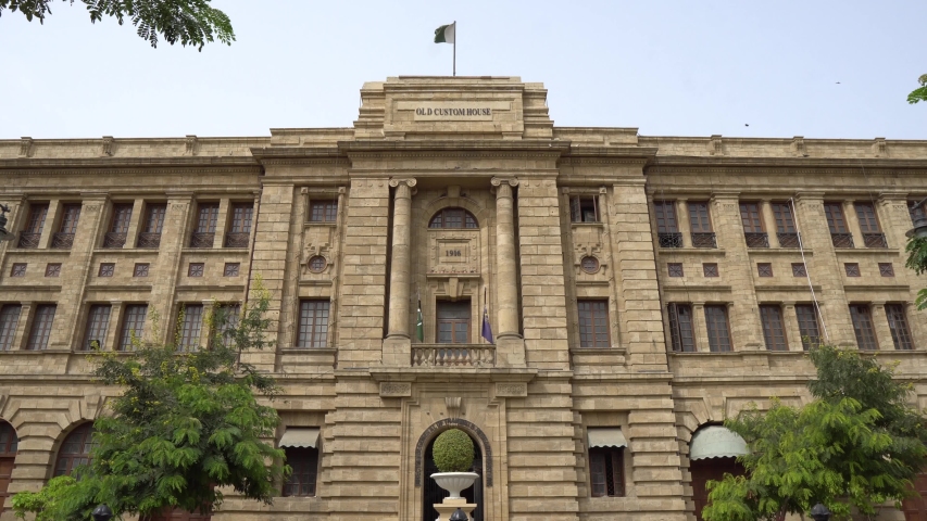 Karachi Imperial Old Custom House Frontal View with Waving Pakistan Flag on Top of Roof on a Cloudy Day