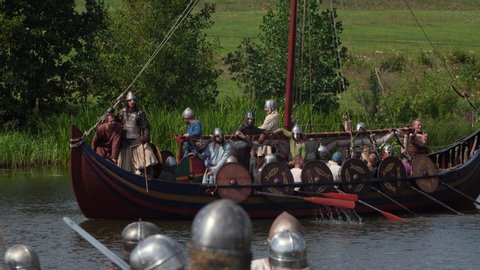 TVER OBLAST, RUSSIA - CIRCA 2019: Combat Viking ship. Medieval warriors. Historical reconstruction.