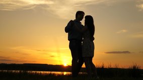 Young couple dancing at sunset on beach. Loving man and woman dance in bright rays of sun on background of the lake. Happy guy and girl waltz in the evening in the summer park. - Powered by Shutterstock - Get 15% off with code: PIKWIZARD15