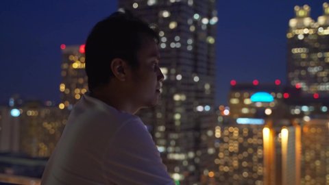 Young Man Enjoying Amazing City Skyline At Night While Looking For Inspiration