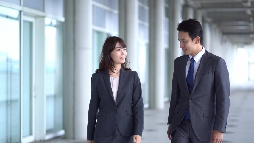 Asian businesspeople walking in passageway | Shutterstock HD Video #1036023500