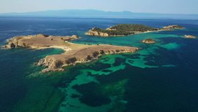 Aerial drone view video of paradise small secluded island complex of Drenia and Pena with turquoise and sapphire sea near famous Amouliani island in North Greece, Halkidiki