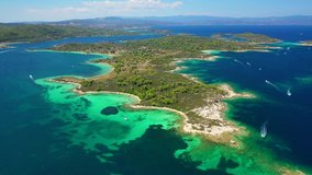 Aerial drone video of famous beaches and turquoise sea in Diaporos island near iconic bay of Vourvourou, Sithonia Peninsula, Halkidiki, North Greece