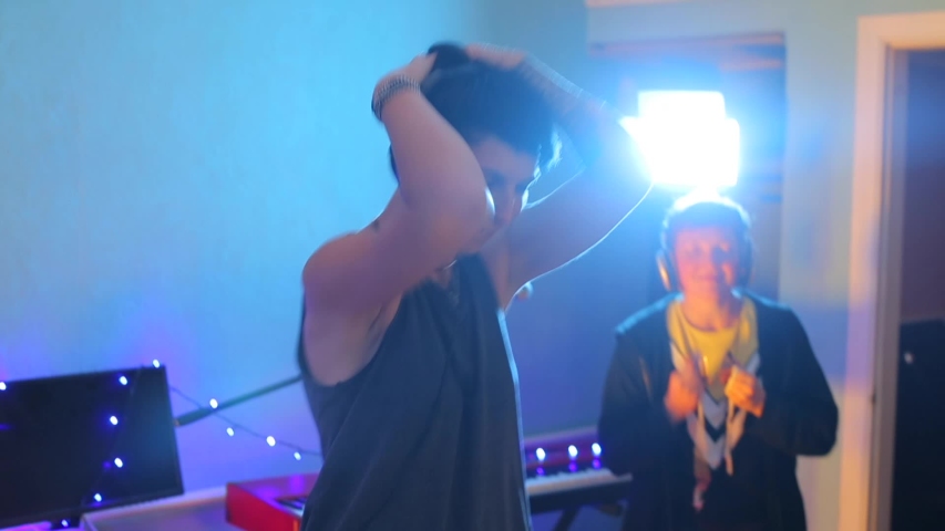 portrait of a girl dancing in headphones at a party