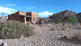 HD resolution cloudy summer morning video footage of red granite boulders rocky desert landscape, lonely lodge chalets and rooms in vast endless empty uninhabited plains