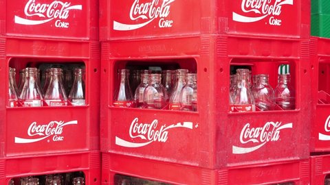 TREBINJE, BOSNIA AND HERZEGOVINA, REPUBLIKA SRPSKA, JULE 5, 2019: Red crates with empty Coca-Cola bottles in fast food restaurant, Trebinje city in Bosnia and Herzegovina