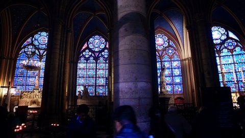 Paris, France - 29 May, 2019: Interior of the Gothic Church of Notre Dame de Paris stained glass windows during a church ceremony.