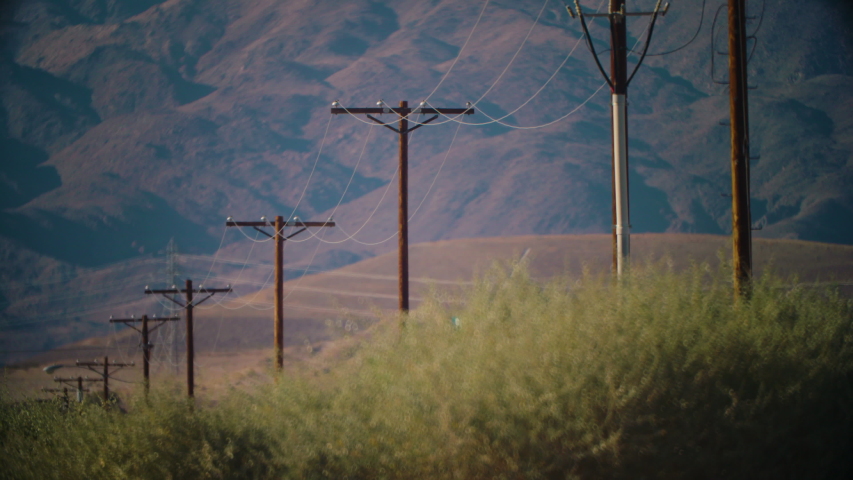 Telephone or power lines descend far into the distance, Riverside County, CA