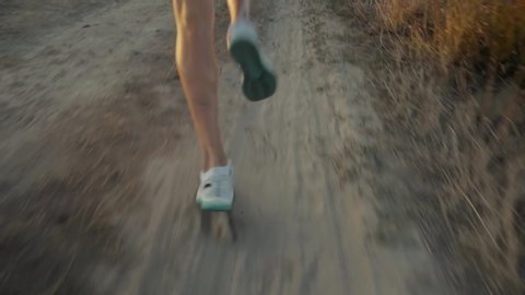 Running Man In Uphill At Sunset Slow Motion.Runner Marathon Jog On Trail.Runner Man Fit Athlete Legs Jogging On City Prepares To Triathlon.Triathlete Running,Sprinting And Workout Endurance Training.