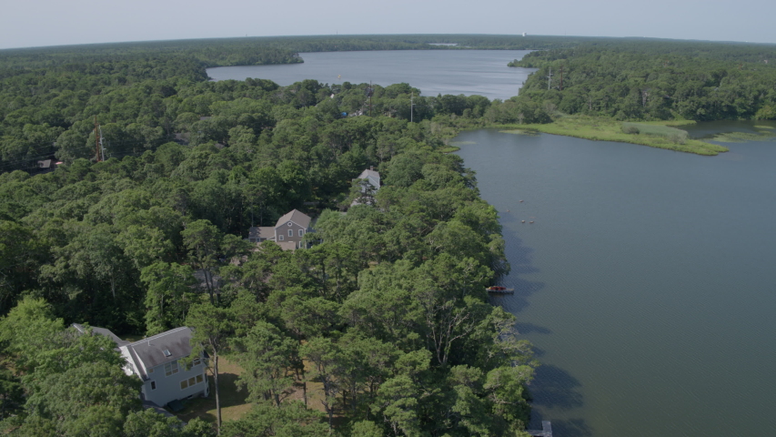 Aerial flyover houses and lakes in Cape Cod, Massachusetts