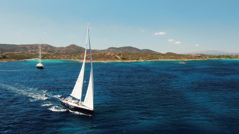Beautiful yacht cruising the crystal clear water of mediterranean sea in Sardinia, Olbia. Italian paradise