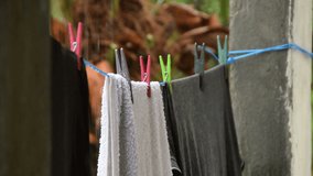 Clean laundry drying on the washing line in the rain.