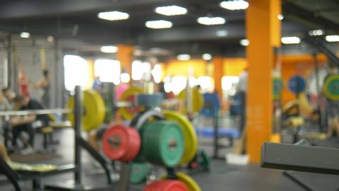 Blur background. barbells in the gym. Blurred fitness room with weight training bar