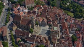 Aerial view of the city Schwäbisch Hall in Germany on a sunny day. Tilt down across the old town.