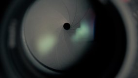 Adjusting aperture camera lens. The camera iris slowly opens and then closes. Aperture blades opening and closing slowly. Camera lens aperture close up. - Powered by Shutterstock - Get 15% off with code: PIKWIZARD15