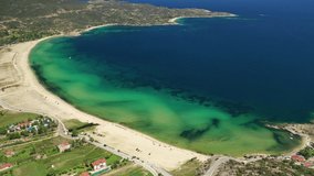 Aerial drone video of iconic turquoise bay and sandy beach of Sykia in South Sithonia  peninsula, Halkidiki, North Greece