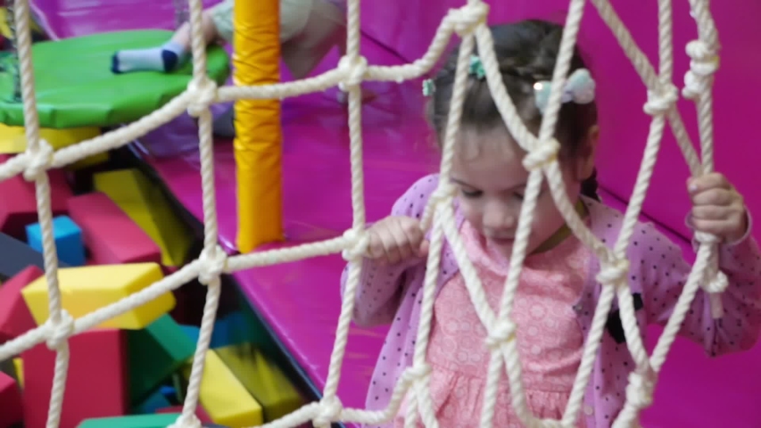 Little girl play in a game center.