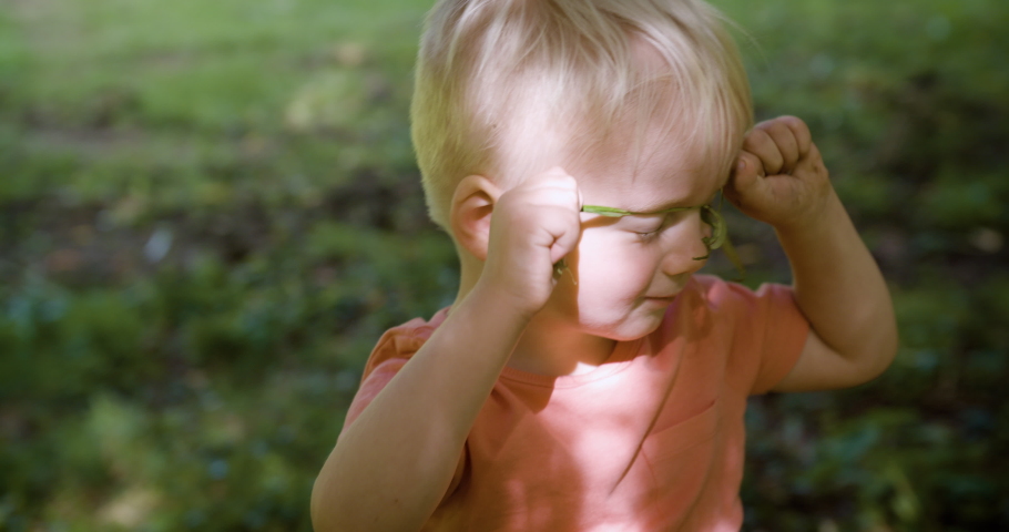 Toddler Playing with a Branch
