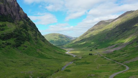 Aerial view of picturesque landscape of Glen Coe, scenic valley in Highlands of Scotland, lush green hills - panorama of Scotland from above, United Kingdom, Great Britain, Europe 库存视频