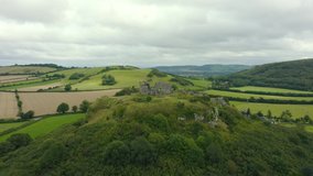 Cinematic 4K aerial panning clockwise shot, background with rolling hills comes into view, Rock of Dunamase, Portlaoise, Ireland.