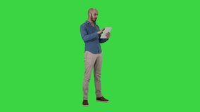 Handsome arabic business man using tablet on a Green Screen, Chroma Key. - Powered by Shutterstock - Get 15% off with code: PIKWIZARD15