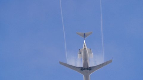 Los Angeles, California / United States - July 11 2019: Small passenger jet passes directly over camera in 180fps slow motion, clear day