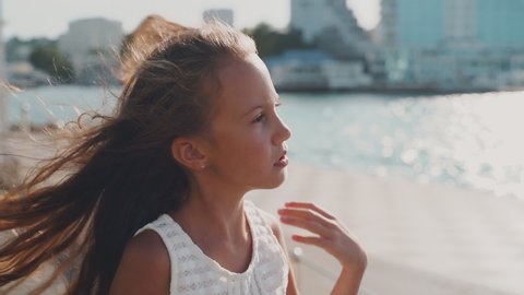 Young girl with long hair looking at sea
