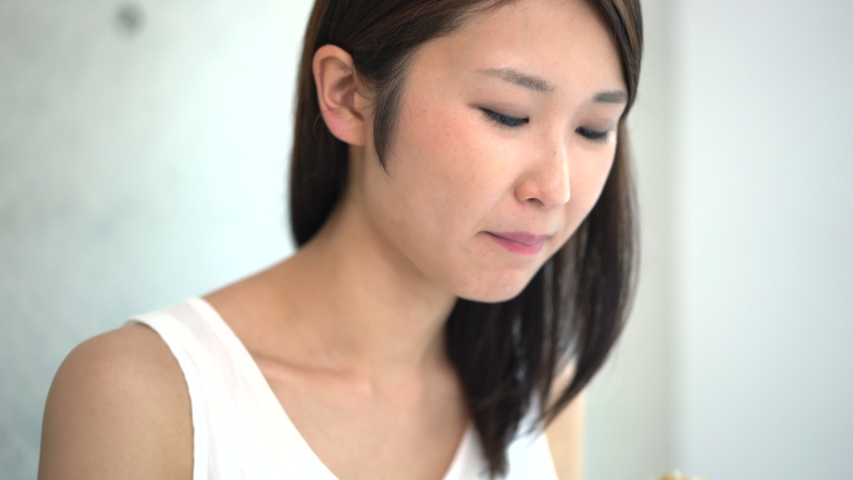 Asian young woman eating curry and rice